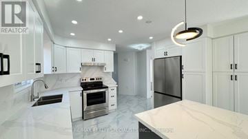 Kitchener apartment for rent - A modern kitchen with white cabinets and a marble countertop.