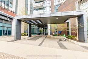 Mississauga (Port Credit) condo for rent - A bicycle is parked under a covered walkway entrance.
