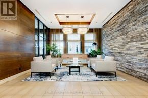 Mississauga (Port Credit) condo for rent - A living room with a stone wall and a wooden floor.