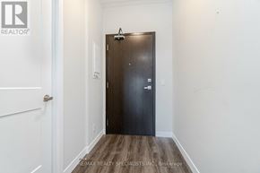 Hamilton (Central) condo for rent - A hallway with a white door and a black door with a brokerage sign.