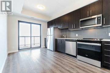 Hamilton (Central) condo for rent - A modern kitchen with dark wood cabinets and stainless steel appliances.