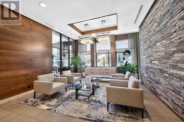 Mississauga (Port Credit) condo for rent - A modern living room with a glass table and chairs.
