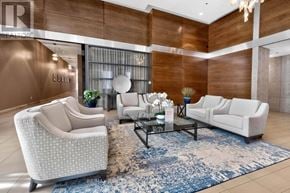 Mississauga (Port Credit) condo for rent - A living room with a sofa, armchair, and coffee table.