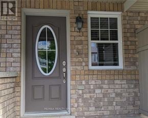 Milton (Ha Harrison) townhouse for rent - A grey door with a glass window above a set of silver handles.