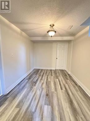 Mississauga (Churchill Meadows) townhouse for rent - A room with a wooden floor and a ceiling fan.