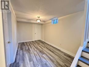 Mississauga (Churchill Meadows) townhouse for rent - A room with wooden flooring and white walls.