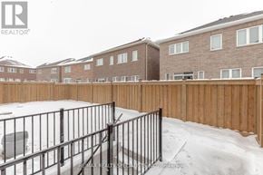 Brampton (Northwest Brampton) apartment for rent - A snow-covered fence in front of a brick building.