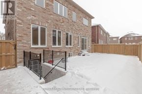Brampton (Northwest Brampton) apartment for rent - A snow-covered yard in front of a brick house.