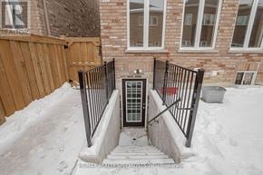 Brampton (Northwest Brampton) apartment for rent - A black gate is in front of a brick house.