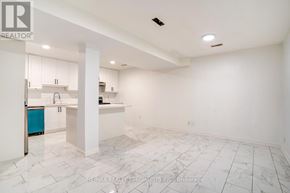 Toronto (Rockcliffe-Smythe) multi-family for rent - A spacious kitchen with white cabinets and a marble floor.