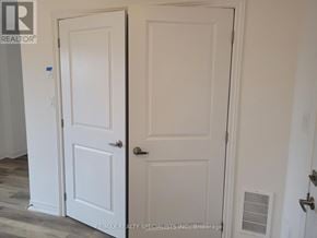 Brant (Paris) townhouse for rent - Two white doors in a room with a brokerage logo.