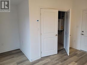Brant (Paris) townhouse for rent - A white door is open to a room with wood flooring.