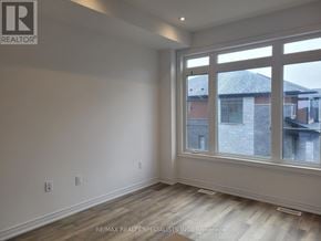 Brant (Paris) townhouse for rent - A room with a large window and wooden flooring.