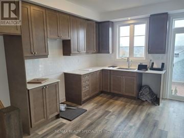 Brant (Paris) townhouse for rent - A kitchen with wooden cabinets and a countertop.