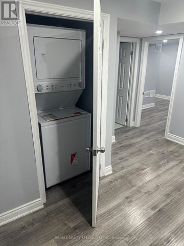Brampton (Fletcher's Meadow) apartment for rent - A white oven and dishwasher are in a kitchen with a wooden floor.