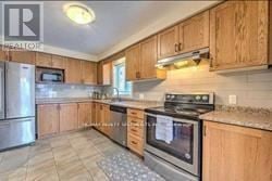 London South (South U) apartment for rent - A kitchen with wooden cabinets and a tile floor.