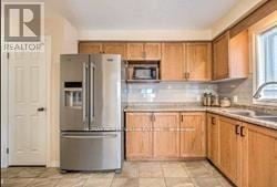 London South (South U) apartment for rent - A kitchen with wooden cabinets and a stainless steel refrigerator.