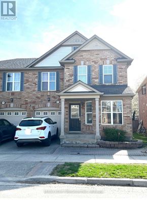Milton (Be Beaty) apartment for rent - A white car is parked in front of a brick house.