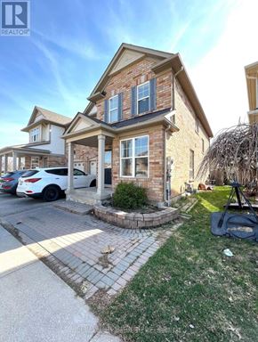 Milton (Be Beaty) apartment for rent - A house with a car parked in front and a sign that says REALTOR.