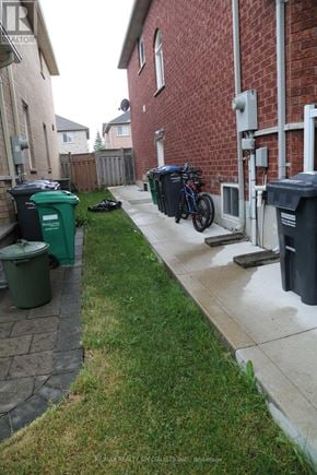 Mississauga (Churchill Meadows) apartment for rent - A residential street with green bins and a bike.