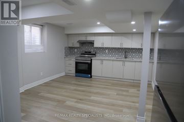 Mississauga (Churchill Meadows) apartment for rent - A kitchen with a stove top oven and a microwave.