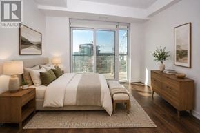 Mississauga (Central Erin Mills) condo for rent - A bedroom with a large bed, a nightstand, and a dresser.