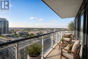 Mississauga (Central Erin Mills) condo for rent - A balcony with a chair and table overlooking a cityscape.