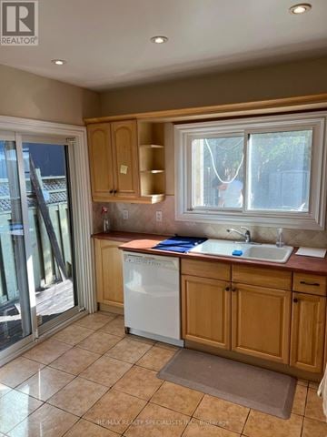Toronto (Humewood-Cedarvale) apartment for rent - A kitchen with a white dishwasher and wooden cabinets.