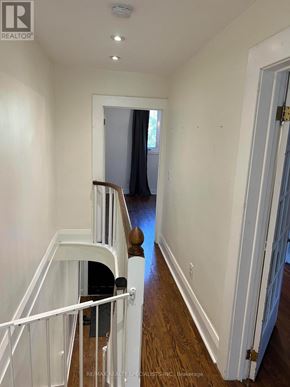 Toronto (Humewood-Cedarvale) apartment for rent - A hallway with a white door and a white railing.