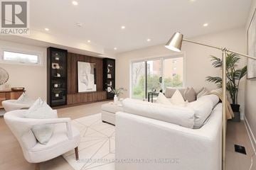 Mississauga (Lakeview) apartment for rent - A well-lit, modern living room with a white sofa and a large window.