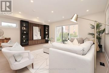 Mississauga (Lakeview) apartment for rent - A well-lit, modern living room with a white sofa and a large window.