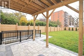 Mississauga (Lakeview) apartment for rent - A wooden pergola over a patio with a black railing.