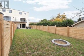 Mississauga (Lakeview) apartment for rent - A backyard with a wooden fence and a fire pit.