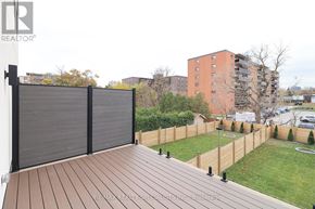 Mississauga (Lakeview) apartment for rent - A wooden deck with a sliding gate in front of a grassy area.