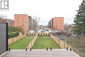Mississauga (Lakeview) apartment for rent - A view of a residential area with apartment buildings and a wooden deck in the foreground.