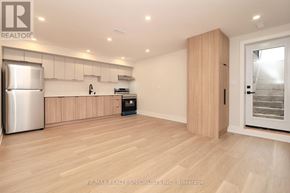 Mississauga (Lakeview) apartment for rent - A kitchen with wooden floors and a refrigerator.