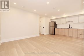 Mississauga (Lakeview) apartment for rent - A spacious kitchen with wooden flooring and white walls.