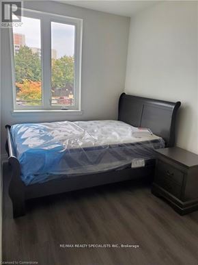 Hamilton (Beasley) condo for rent - A bedroom with a bed, nightstand, and window.