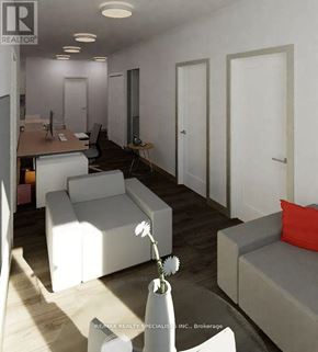 Hamilton (Beasley) condo for rent - A living room with white furniture and a vase of flowers on a table.