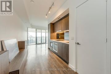 Toronto (Waterfront Communities) condo for rent - A modern kitchen with wooden cabinets and a large island.