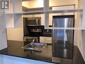 Toronto (Etobicoke West Mall) condo for rent - A modern kitchen with a stainless steel refrigerator and a sink.
