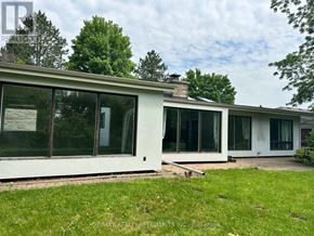 Vaughan (Islington Woods) apartment for rent - A white house with a glass door and a green lawn in front.