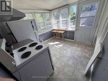 Mississauga (Clarkson) apartment for rent - A kitchen with a stove and a window with blinds.