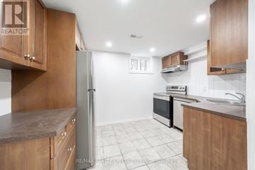 Burlington (Brant) apartment for rent - A kitchen with wooden cabinets and a refrigerator.