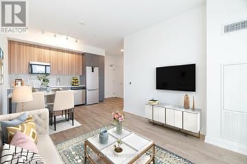 Hamilton (Kirkendall) condo for rent - A living room with a white couch and a coffee table in the middle.
