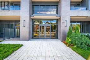 Hamilton (Kirkendall) condo for rent - The front of a building with a glass entrance and a brick facade.