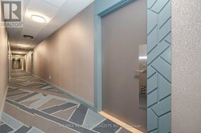 Hamilton (Kirkendall) condo for rent - A hallway with a blue and white patterned wall and a door with the number 703 on it.
