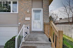 Kitchener apartment for rent - A house with a white door and a number 11 on the wall.