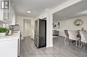 Kitchener apartment for rent - A kitchen with a refrigerator, sink, and dining area.