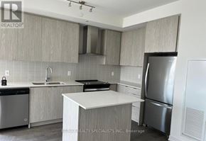 Kitchener condo for rent - A kitchen with a white countertop and stainless steel appliances.